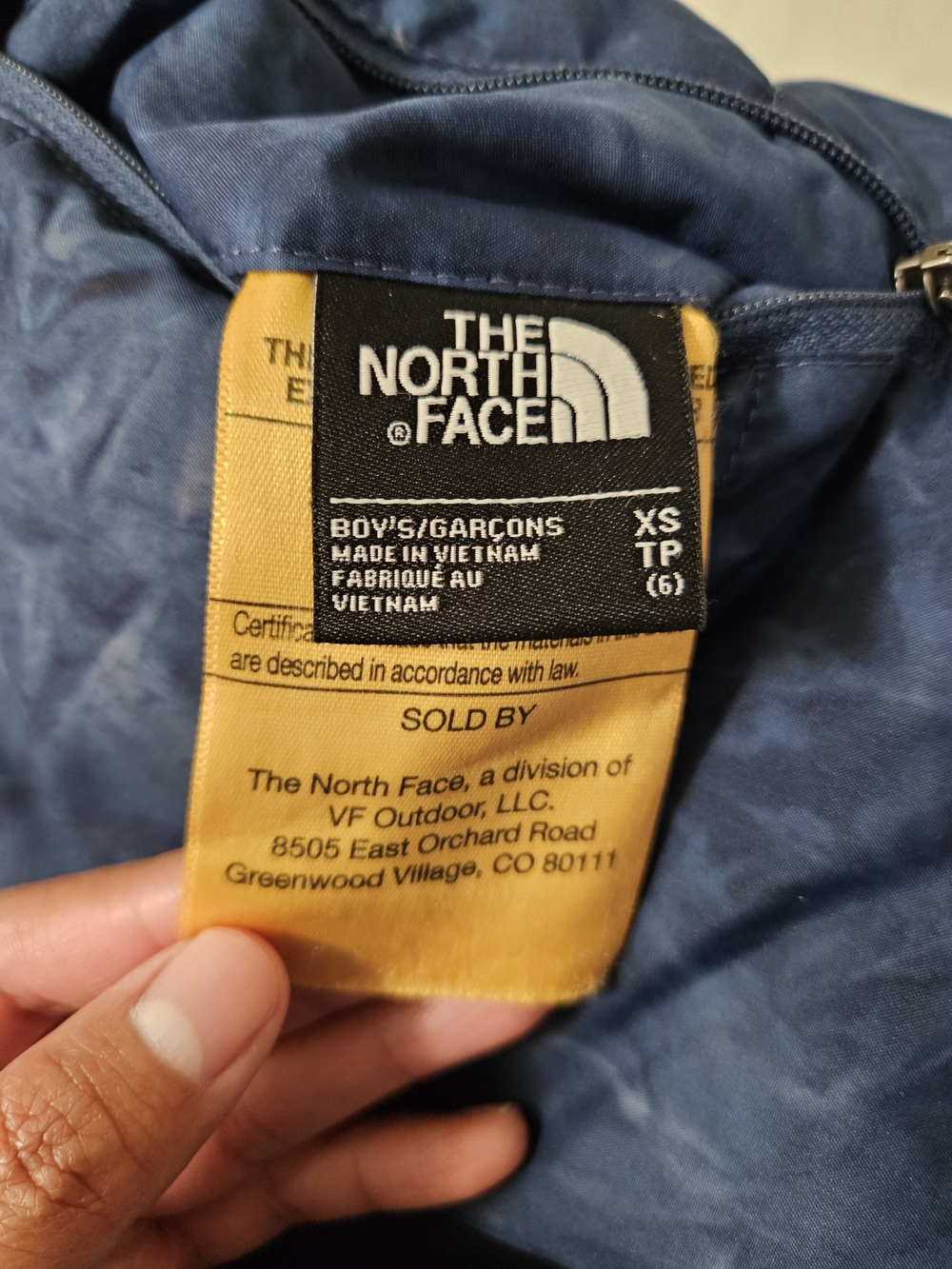 The North Face navy blue jacket with yellow tag